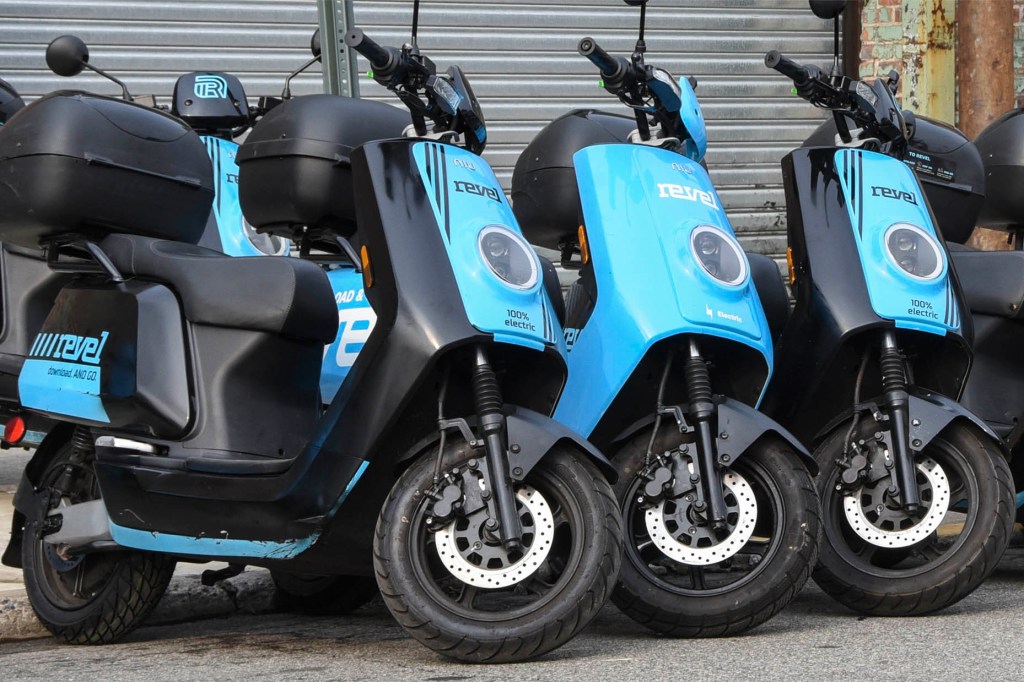 Revel scooters lined up on the street.