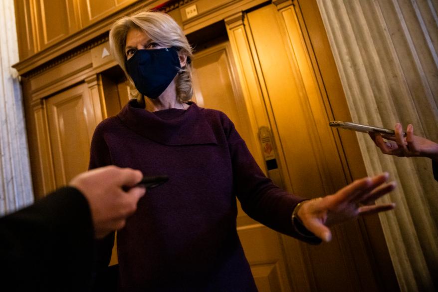 Sen. Lisa Murkowski talking to reporters after leaving the Senate floor on January 26, 2021.