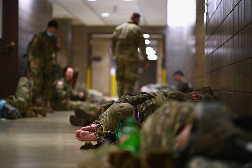 National Guard troops rest in the Dirksen building on US Capitol grounds after the inauguration of President Joe Biden on Jan. 20, 2021.