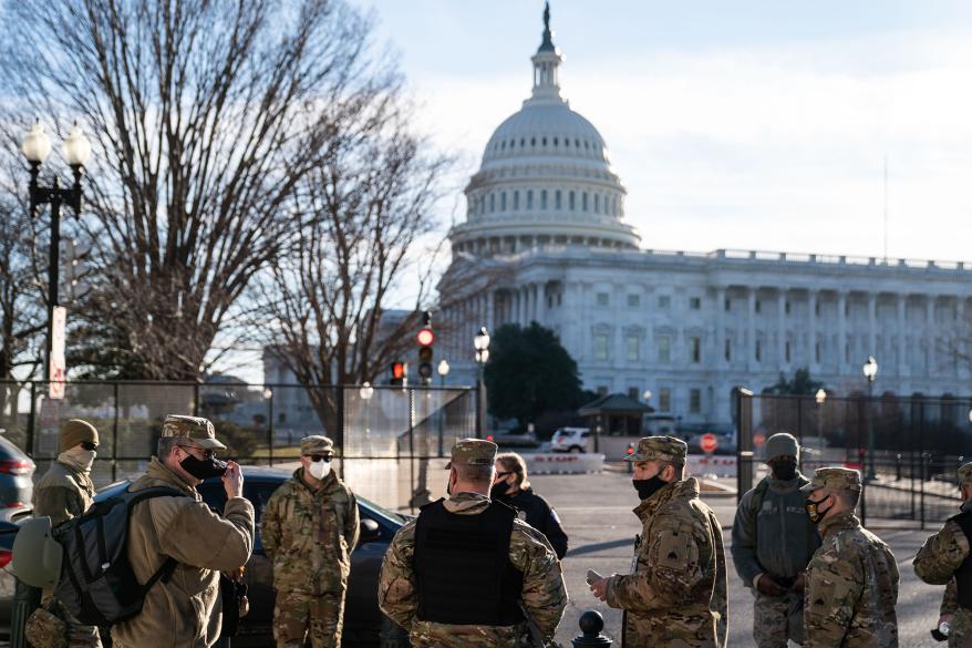 Members of the National Guard stand across the street near the Senate office buildings following the Capitol riots.