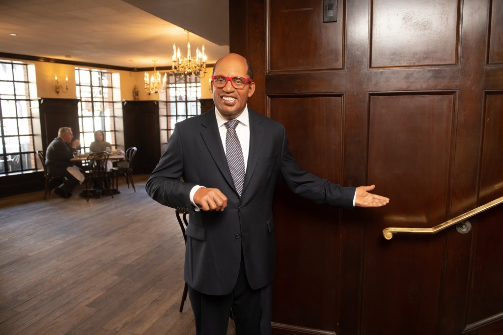 A Madame Tussauds wax figure of NBC weatherman and TV personality Al Roker guides patrons to the second story dining room.