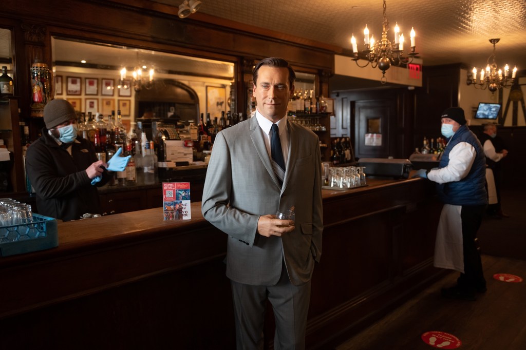 A Madame Tussauds wax figure of “Mad Man” star Jon Hamm holds a glass of whiskey by the bar at Peter Luger Steak House.