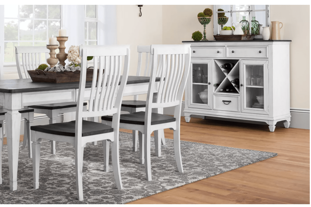 A white dining room chair and table set with a white cabinet 