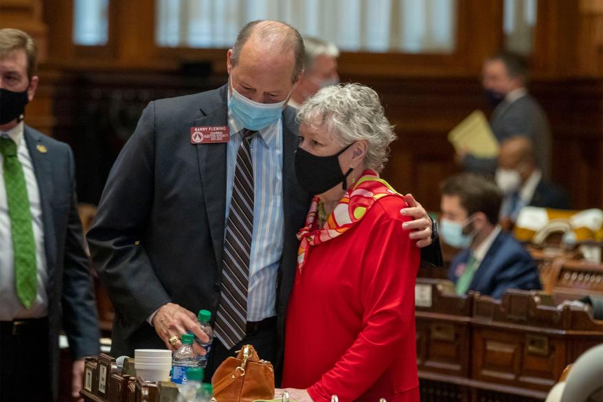 Rep. Barry Fleming receives a hug from Rep. Lynn Smith, R-Newnan, after a bill he sponsored, SB 202, passed in the House Chambers in a legislative session at the Georgia State Capitol Building in Atlanta, Thursday, March 25, 2021.