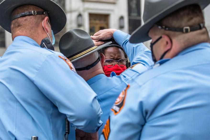 State Rep. Park Cannon, D-Atlanta, is placed into the back of a Georgia State Capitol patrol car after being arrested by Georgia State Troopers at the Georgia State Capitol Building in Atlanta, Thursday, March 25, 2021.