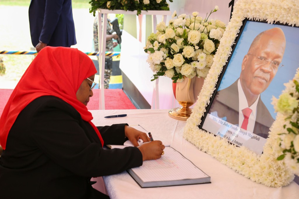 Tanzania's new president Samia Suluhu Hassan signs a book of condolences for former president John Magufuli.