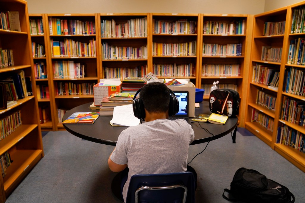  In this Aug. 26, 2020, file photo, a Los Angeles Unified School District student attends an online class at the Boys & Girls Club of Hollywood in Los Angeles. 