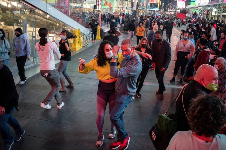 Revelers danced in Times Square as spring-like temperatures set in Thursday.