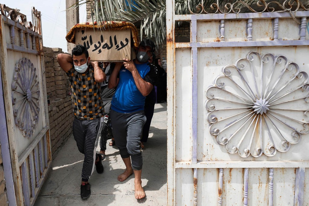 Iraqis transport the coffin of a relative who was killed during a fire at the Ibn al-Khatib hospital 