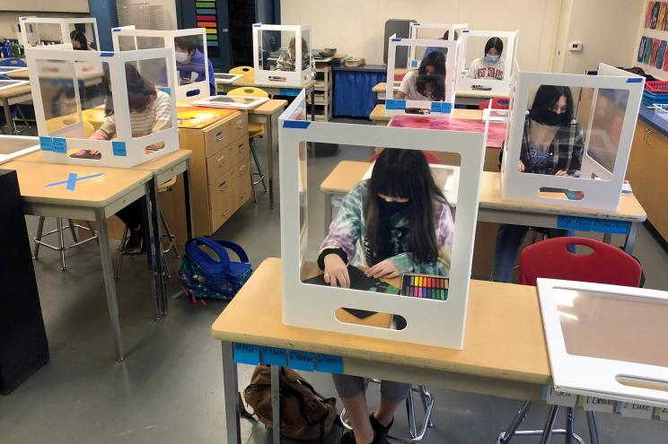 Socially distanced, and with protective partitions, students work on an art project during class at the Sinaloa Middle School in Novato, Calif. on March 2, 2021.