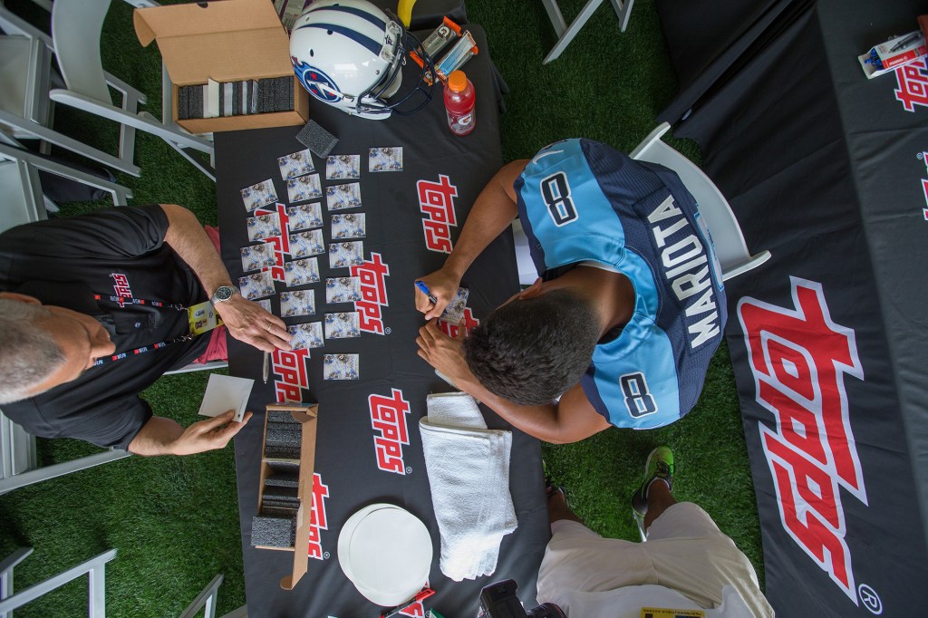 Tennessee Titans quarterback (8) Marcus Mariota signs football cards for Topps at the NFLPA Rookie Premiere at the Los Angeles Memorial Coliseum, Saturday, May 30, 2015, in Los Angeles.