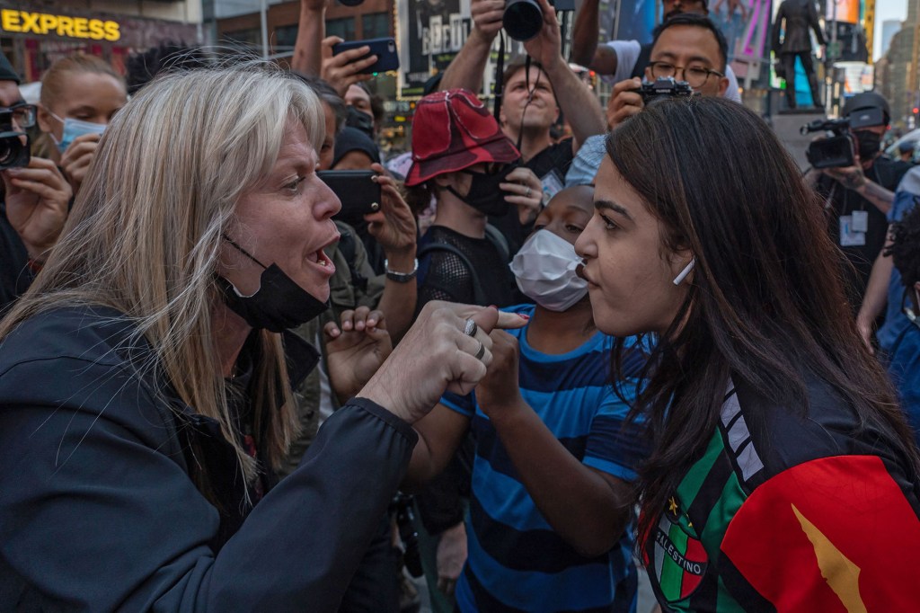 Pro-Palestinian protesters face off with a group of Israel supporters and police in a violent clash in Times Square during a rally in support of Israel on May 20, 2021.