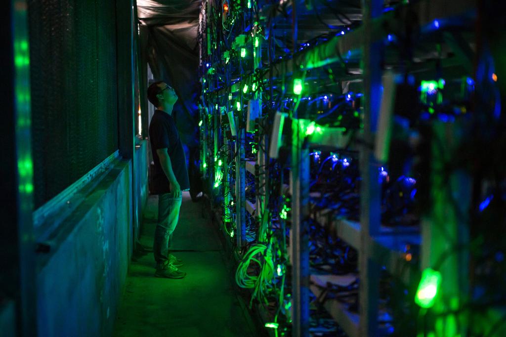 A bitcoin mine site manager seen inside the facility near Kongyuxiang, Sichuan, China.