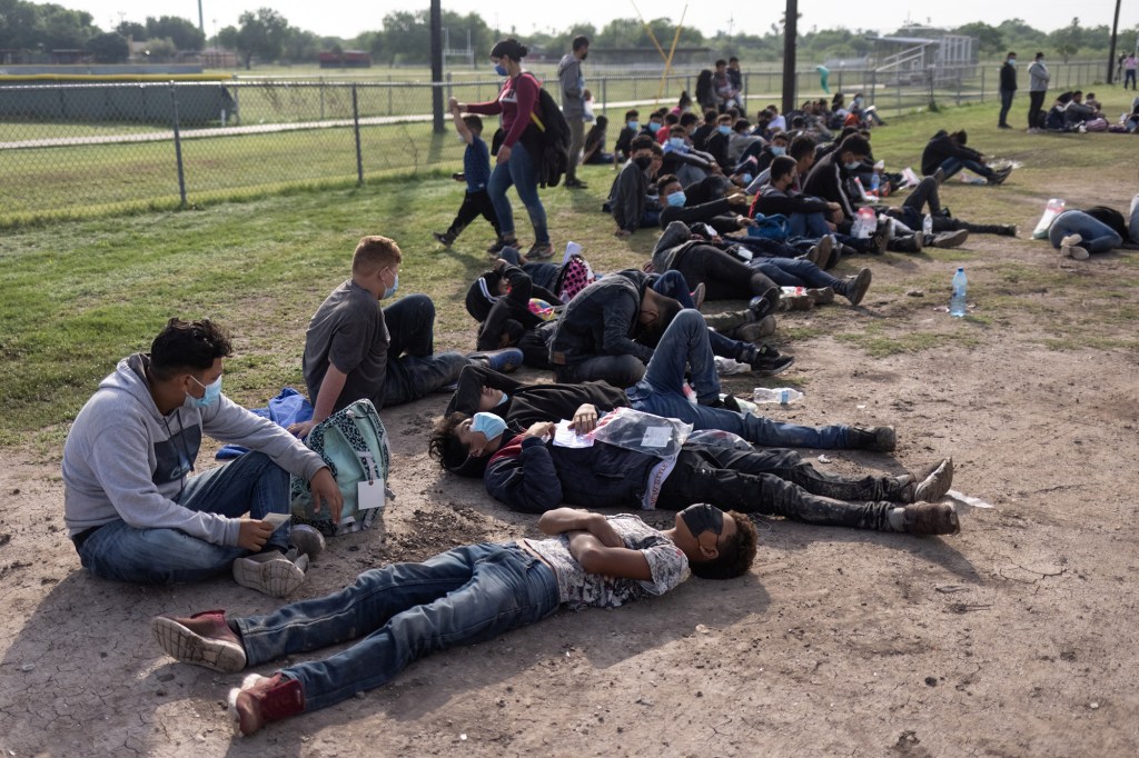 Dozens of asylum seeking unaccompanied minors from Central America rest after surrendering to U.S. border patrol agents after crossing the Rio Grande river into the United States from Mexico in La Joya, Texas