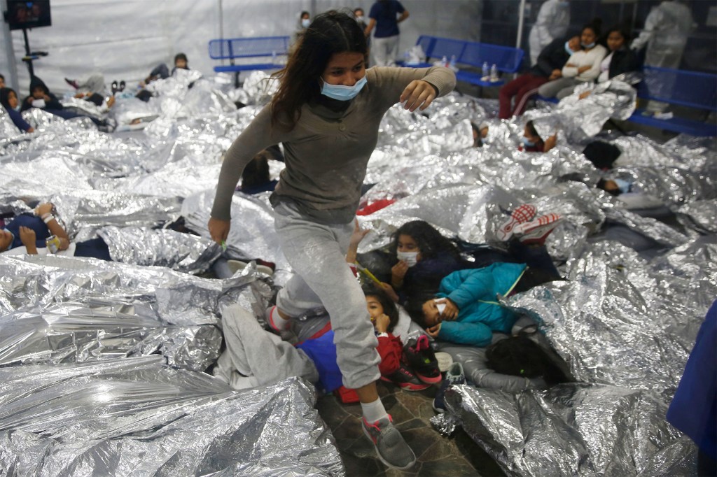 Migrant children in foil blankets at a DHS holding facility in Donna, Texas on March 20, 2021.