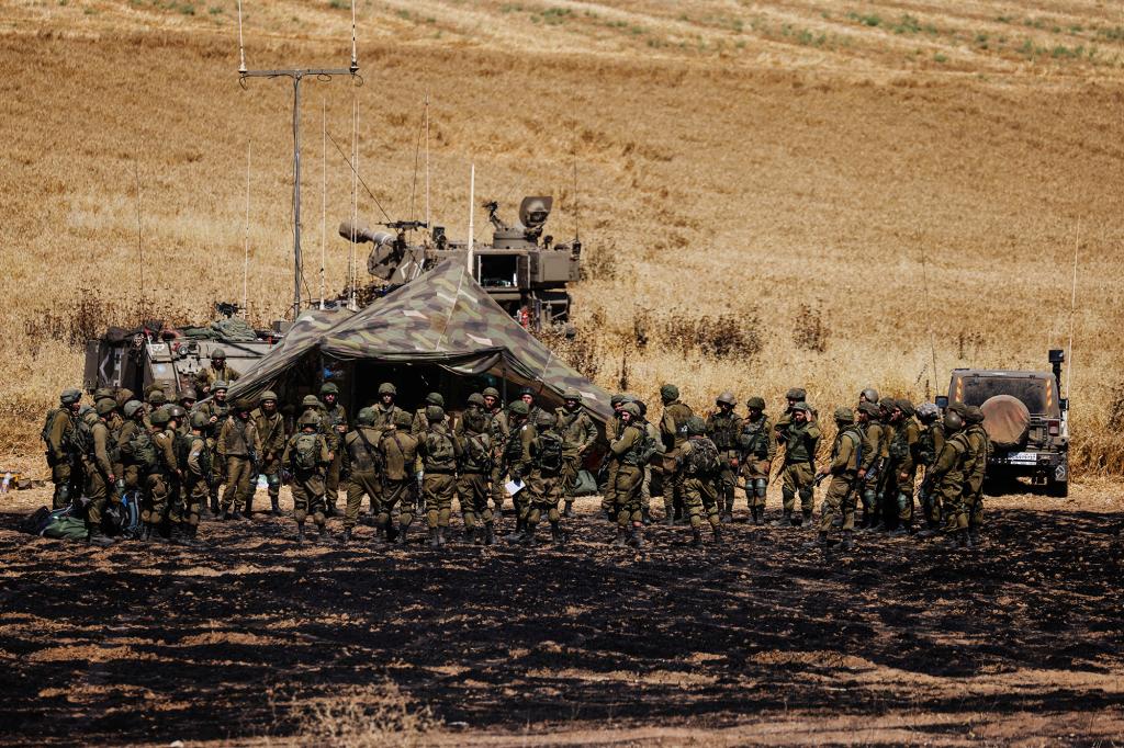 Israeli soldiers gather near the border between Israel and the Gaza Strip, on its Israeli side on May 14, 2021.