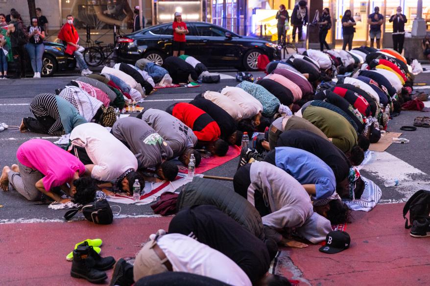 Protesters pray outside of the 17th precinct.