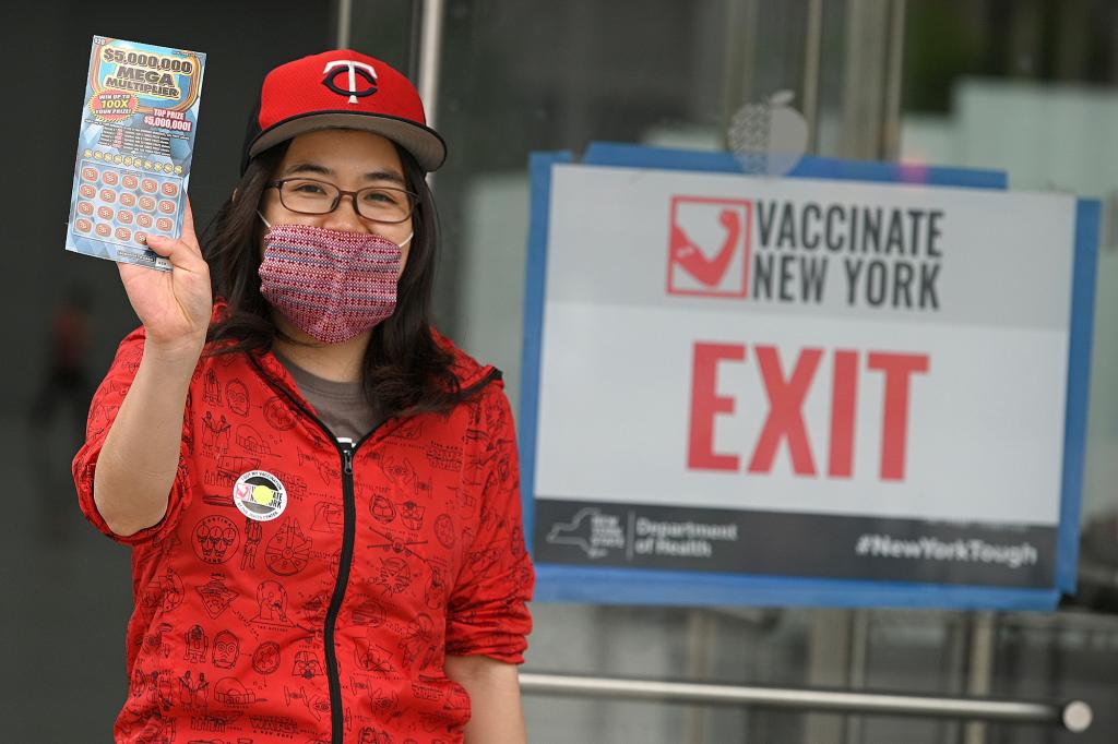 A woman holding a lottery ticket she got for getting vaccinated at the Javits Center on May 24, 2021.