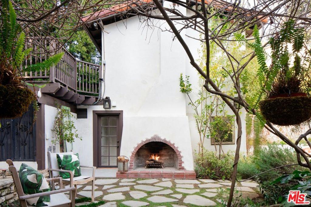 On oversized outdoor Spanish fireplace graces the quarter-acre lot.