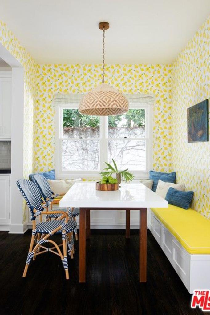 The kitchen has a bright breakfast nook pictured in sunny yellow.