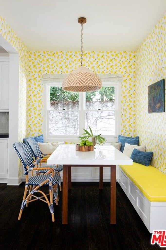 The kitchen has a bright breakfast nook pictured in sunny yellow. 