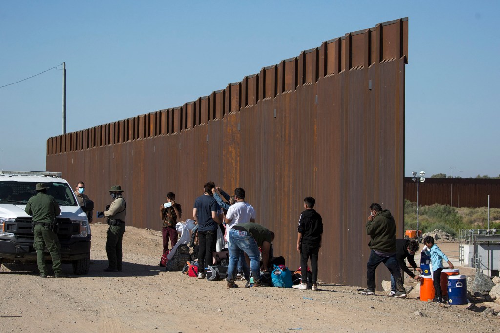 Migrants from Columbia wait to be processed after turning themselves over to authorities at the United States-Mexico border. 