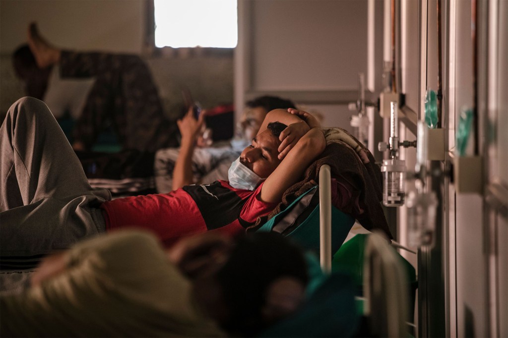 A line of COVID-19 patients rest at the Radhaswami Isolation center in Kathmandu, Nepal on May 25, 2021.