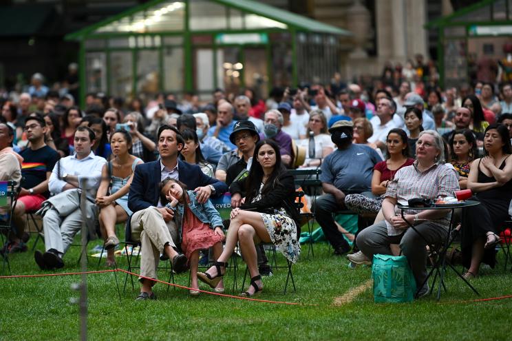 People watch performers from City Opera's Pride Series sing at the Pride in the Park Picnic Performances in Bryant Park on June 18, 2021 in New York City.