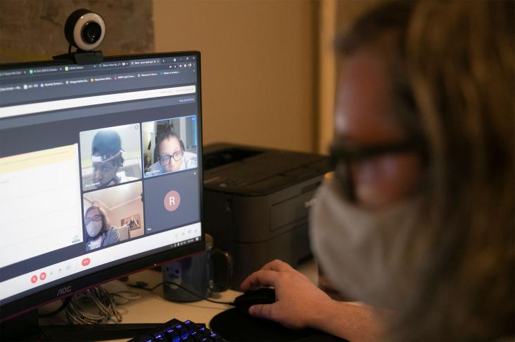 Ryan Mann, tech coordinator at William Dick Elementary, does remote learning with students Ziara Johnson, left, and Devynn Birton inside his West Philadelphia home on Wednesday, April 28, 2021.