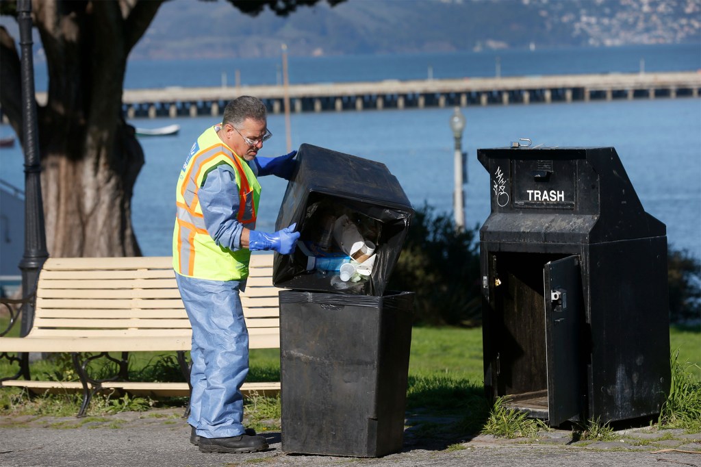 Randy Price with SF Public Works removes trash from Aquatic Park in San Francisco