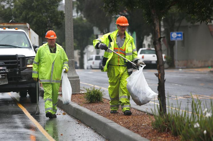 City workers clear street trash on Alemany Blvd. north of Santa Rosa St