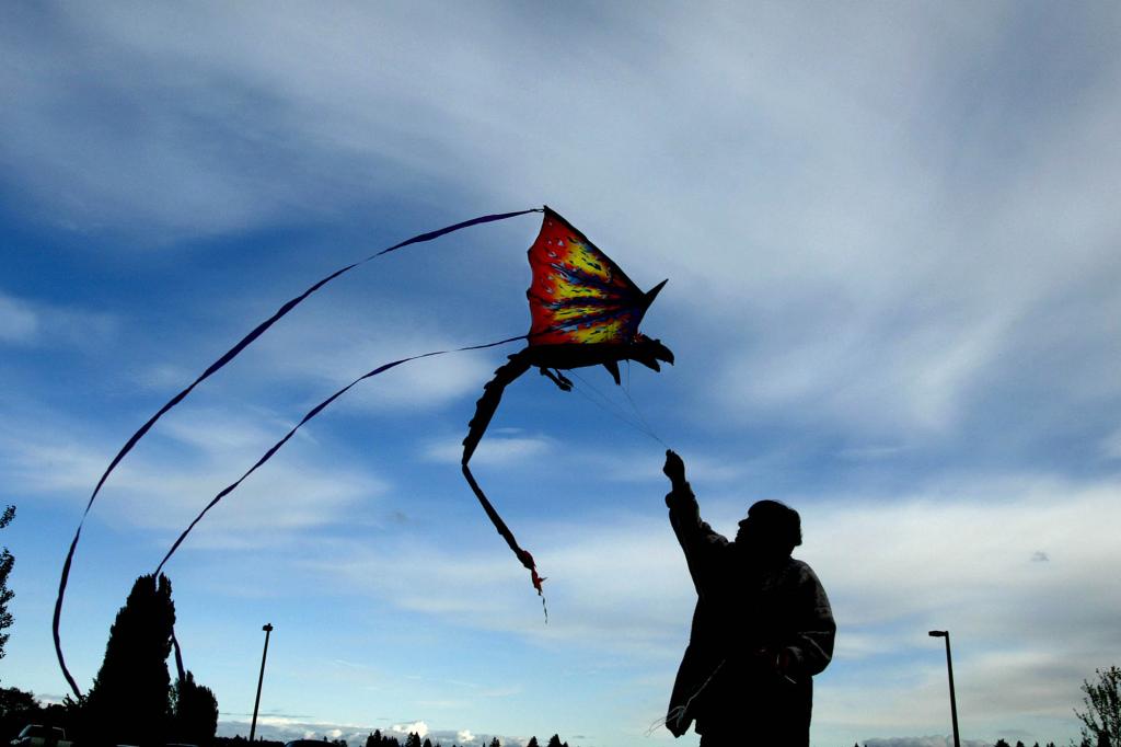 Chris Shults from Bremerton, Wash., flies her dragon kite in the parking lot next to the Lions Park Dock Wednesday, May 21, 2008 in Bremerton, Wash.