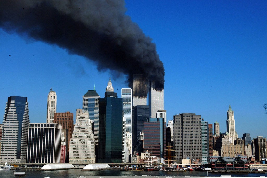 The twin towers of the World Trade Center billow smoke after hijacked airliners crashed into them early September 11, 2001.