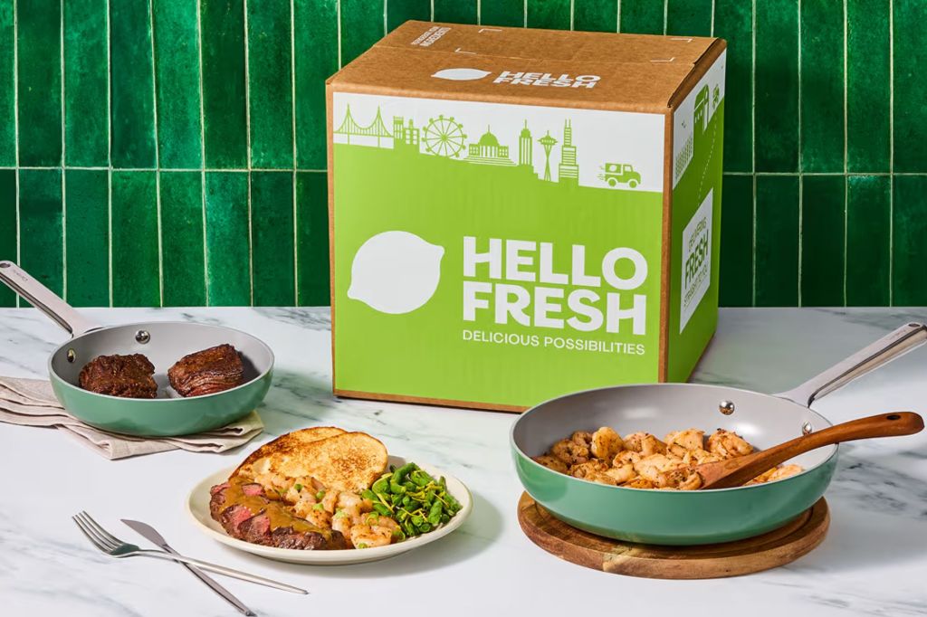 A box with the words HelloFresh next to food in a pan and on a plate.