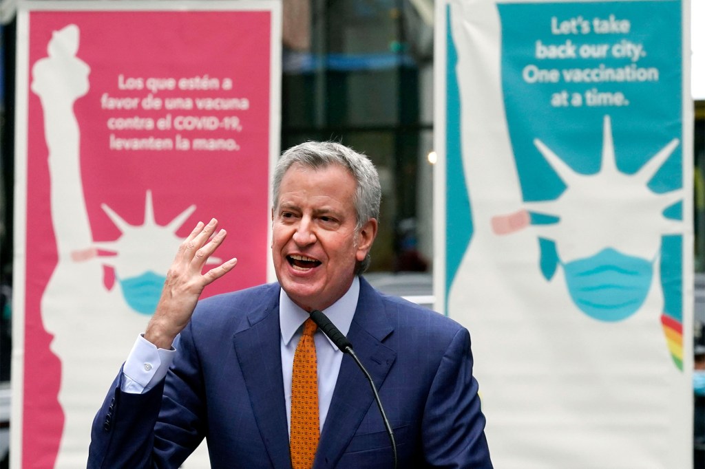 In this Monday, April 12, 2021 file photo, New York Mayor Bill de Blasio delivers remarks in Times Square after he toured the grand opening of a Broadway COVID-19 vaccination site intended to jump-start the city's entertainment industry, in New York.