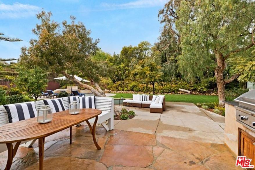 Patio furniture dots an outdoor seating area.