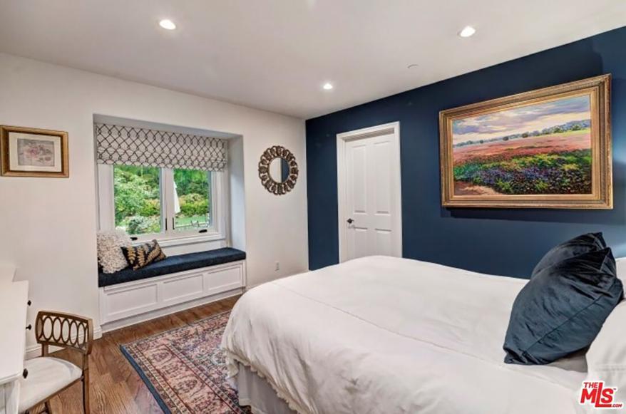 The same bedroom is shown from another angle, revealing a reading nook.