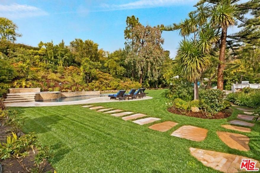 A stone walkway leads to the pool.