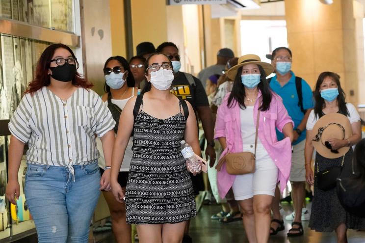 People walking with masks on in a shopping district in Hollywood on July 1, 2021.