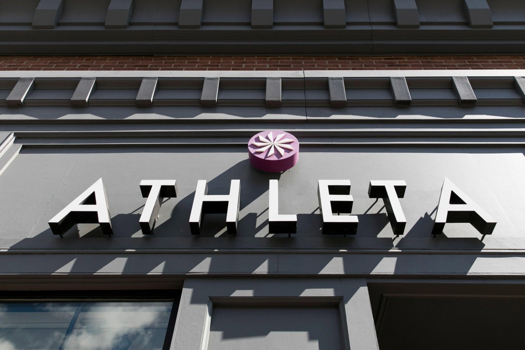 A logo sign outside of a Athleta retail store location.