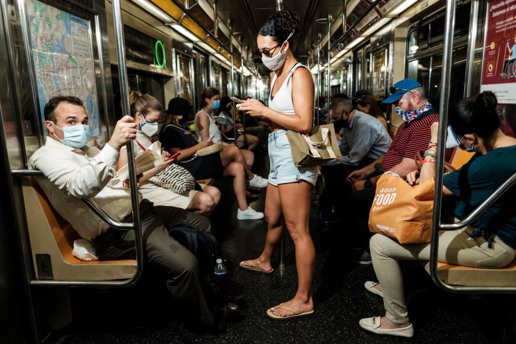 People on the subway wearing masks.