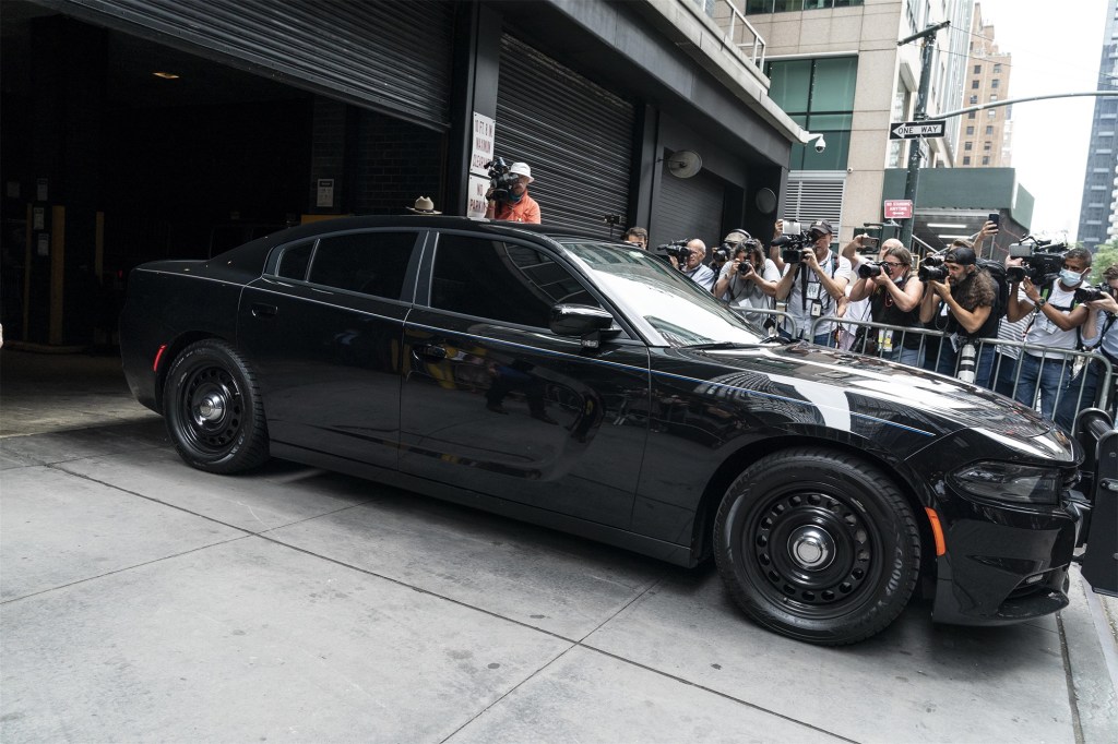 A car driven by Andrew Cuomo is seen leaving a parking garage after he resigned as governor on Tuesday.