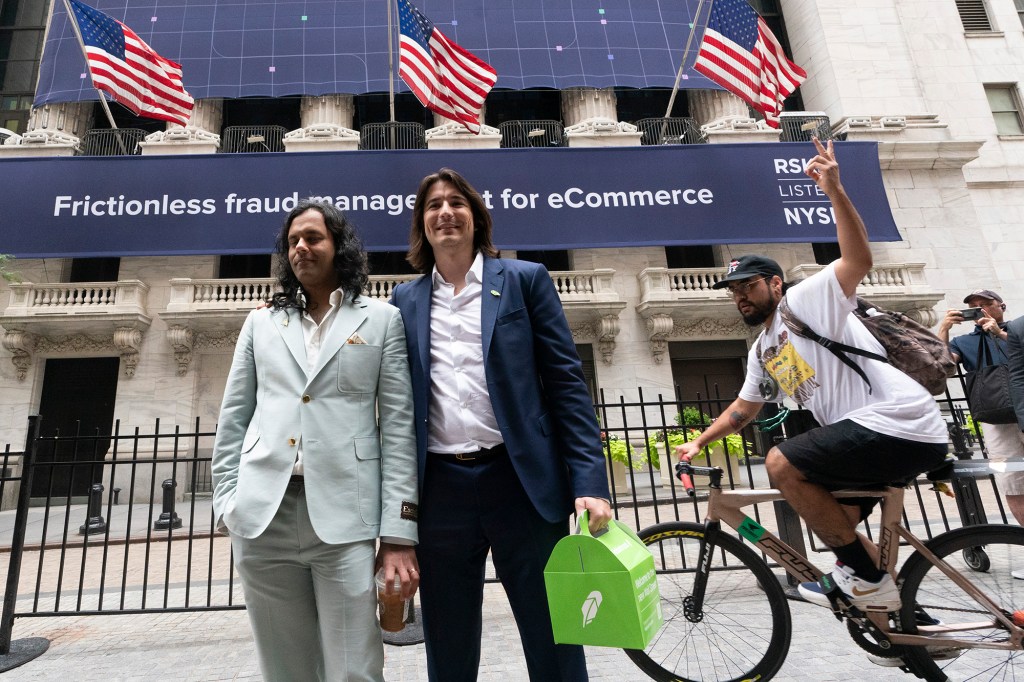 Baiju Bhatt, left, and Vladimir Tenev, co-founders of Robinhood, walk by the New York Stock Exchange following their company's IPO at Nasdaq on July 29, 2021.