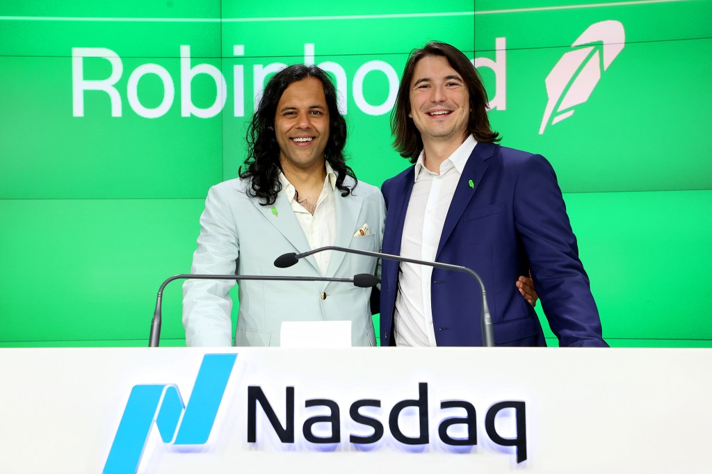 Baiju Bhatt and Vlad Tenev standing at podium with signage reading Nasdaq