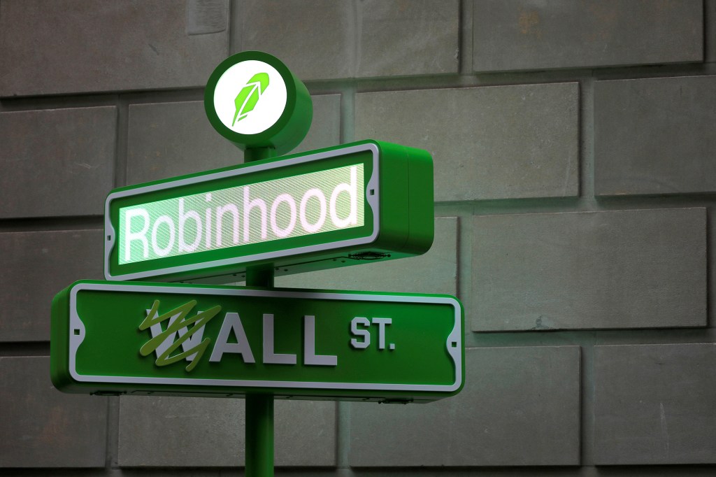 Logo of Robinhood on a faux street sign above a faux Wall Street sign 