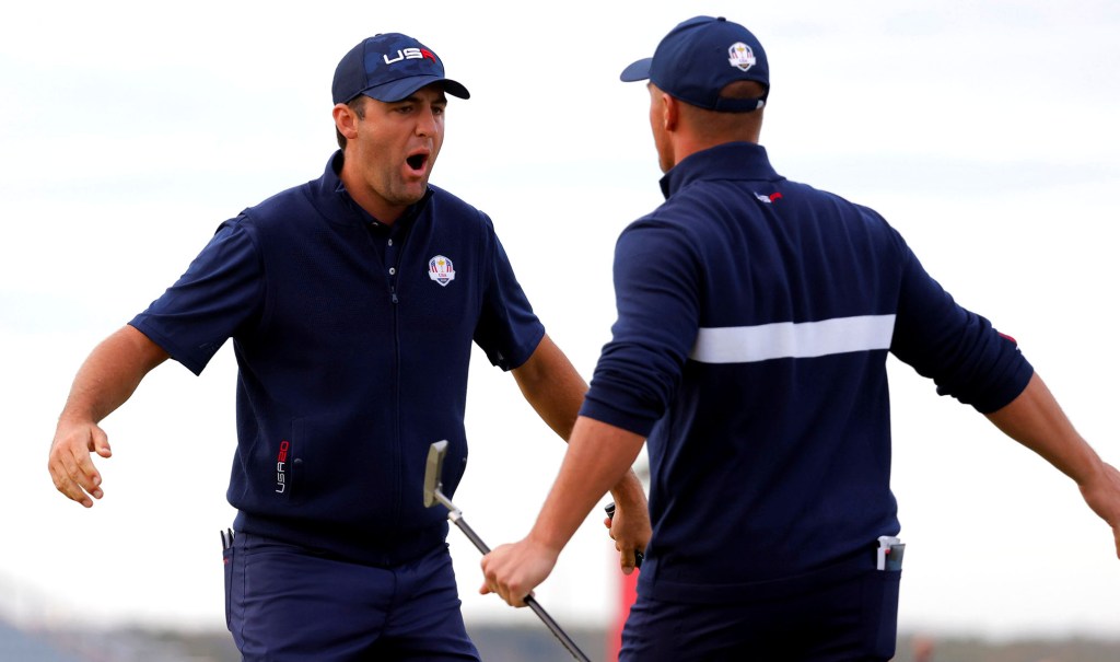 Scottie Scheffler (left) celebrates with partner Bryson DeChambeau after making a birdie on the 15th hole at the Ryder Cup.