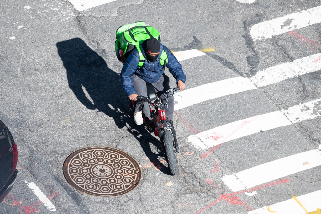  An Uber Eats delivery person rides a bicycle in Kips Bay on March 19, 2021 in New York City. After undergoing various shutdown orders for the past 12 months the city is currently in phase 4 of its reopening plan, allowing for the reopening of low-risk outdoor activities, movie and television productions, indoor dining as well as the opening of movie theaters, all with capacity restrictions. 