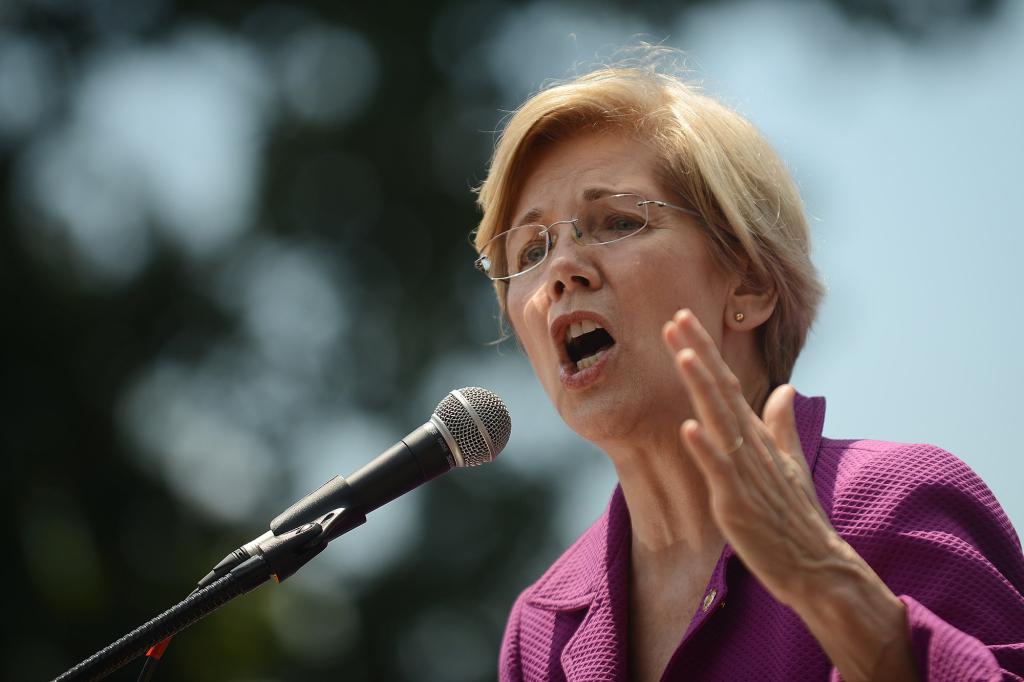 Elizabeth Warren speaking before a microphone