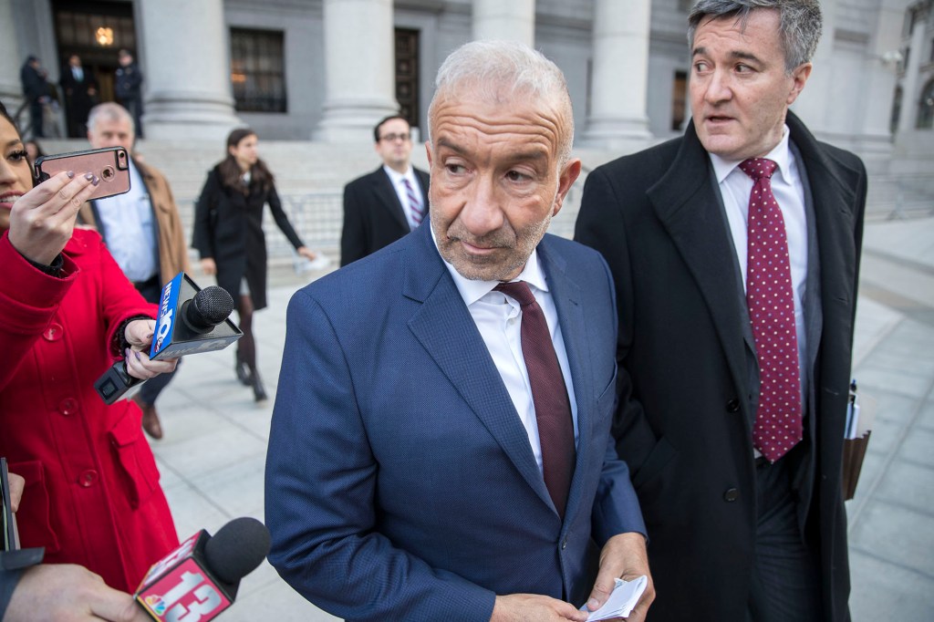 Alain Kaloyeros walks out of Manhattan Federal Court after being sentenced to 42 months in jail.