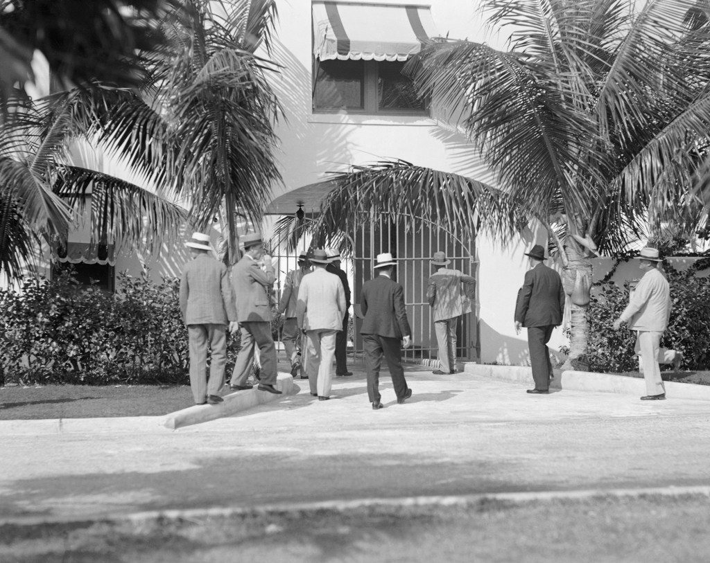 Photo shows men from the Sheriff's Department of Dade County, entering Al Capone's home at Miami Beach, Florida, for a raid.